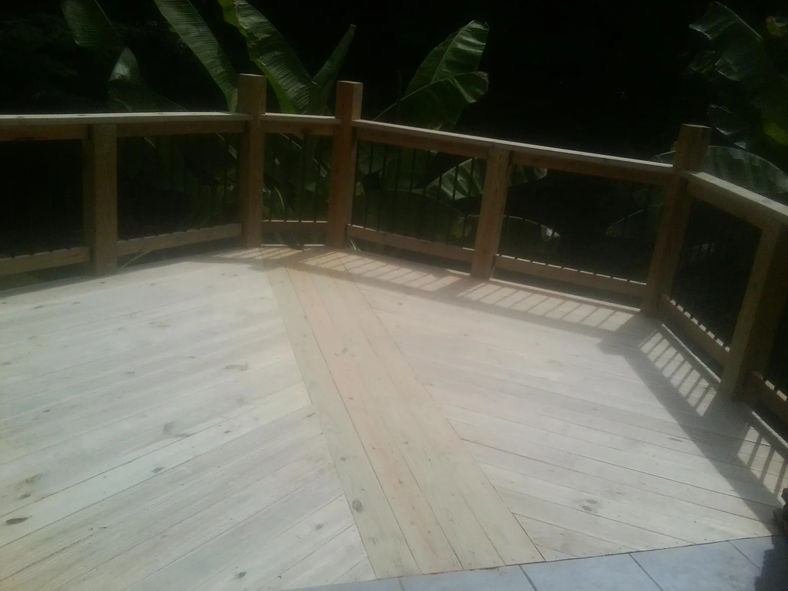 New wood deck and railing built off the back of a home in East Schodack